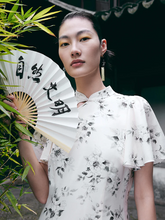 a lady wearing cheongsam dress and holding a fan
